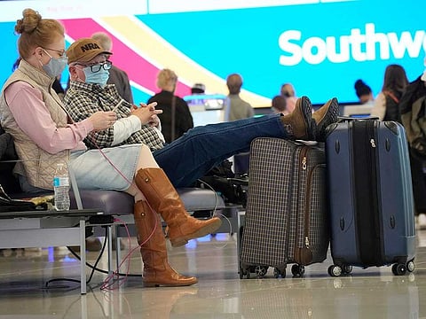 Travellers wait at the check-in counter for Southwest Airlines in the terminal of Denver International Airport. More than 200 flights were cancelled by carriers out of Denver International because COVID-19 issues have created a shortage of workers. 