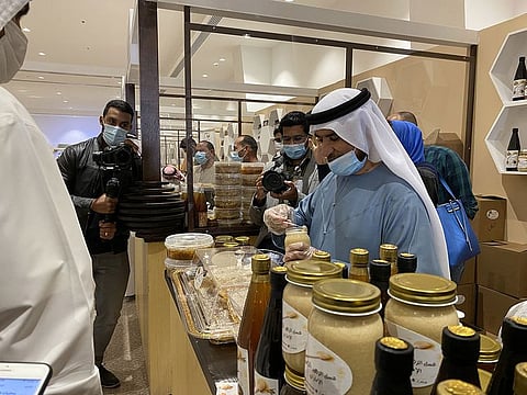 Visitors take a look at the various kinds of honey at the Hatta Honey Festival on Sunday.