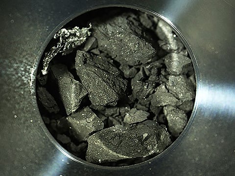 Optical microscope photo provided by the Japan Aerospace Exploration Agency (JAXA) shows soil samples, seen inside C compartment of the capsule brought back by Hayabusa2, in Sagamihara, near Tokyo.  