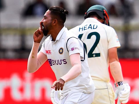 India's Mohammed Siraj (L) celebrates the dismissal of Australia's Travis Head (R) on the third day of the second cricket Test match between Australia and India at the MCG in Melbourne on December 28, 2020.
