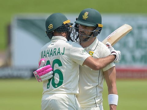 South Africa's Faf du Plessis (right) being embraced by teammate Keshav Maharaj on reaching the 150-mark on third day of first  Test in Pretoria, South Africa on Monday. 
