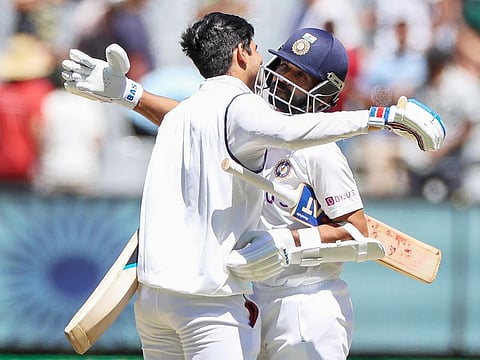 India's Ajinkya Rahane, right, and teammate Shubman Gill embrace as they celebrate after winning the second Test against Australia at the Melbourne Cricket Ground. 