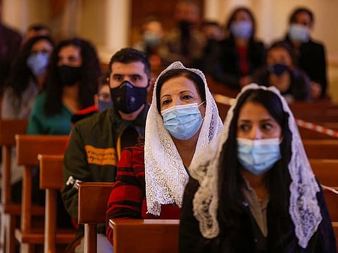 People wearing protective masks and practicing social distancing attend a Mass at Church of the Sacred Heart, as they take part in Christmas celebrations amid the coronavirus disease (COVID-19) pandemic, in Amman, Jordan, December 24, 2020. 
