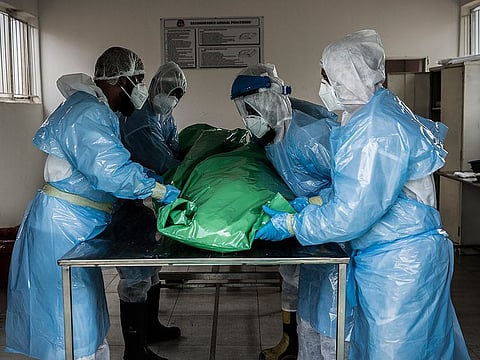 Members of the Saaberie Chishty Burial Society prepare the body of a person who died from COVID-19 at the Avalon Cemetery in Lenasia, Johannesburg, on December 26, 2020. 