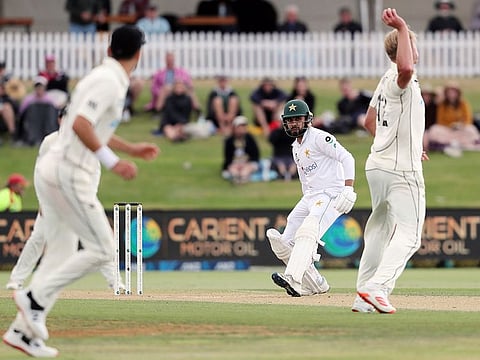 Pakistan’s batsman Faheem Ashraf (C) looks to avoid the throw from New Zealand’s Kyle Jamieson (R) on day three of the first cricket Test match between them at the Bay Oval in Mount Maunganui on December 28, 2020.  