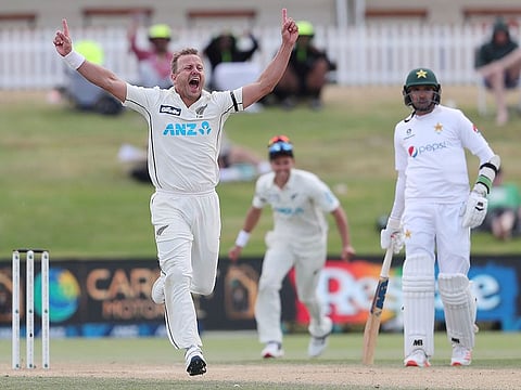 New Zealand’s Neil Wagner (L) celebrates after taking the wicket of Pakistan’s Faheem Ashraf (R) during the fifth day of the first cricket Test match at the Bay Oval in Mount Maunganui on December 30, 2020.  