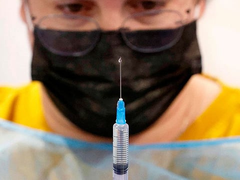 A healthcare worker prepares a dose of the Pfizer-BioNtech COVID-19 vaccine at a large vaccination centre open by the Tel Aviv-Yafo Municipality and Tel Aviv Sourasky Medical Center on December 31, 2020 in the Israeli coastal city.