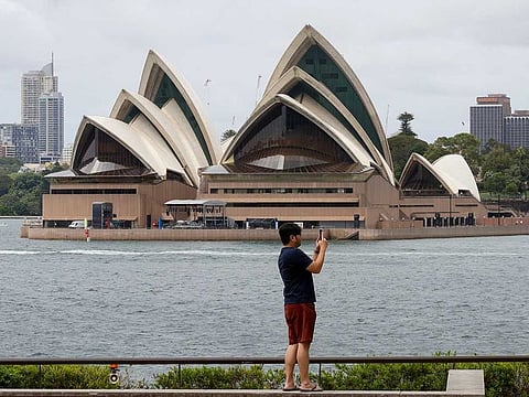 A man uses his mobile phone in Sydney, Australia.