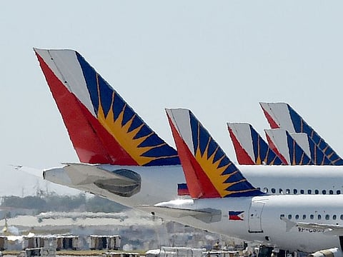Tail sections of Philippine airlines (PAL) aircrafts are seen parked at the terminal II building of the Manila international airport