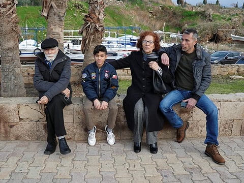 Bassam Akiki, 48, a Lebanese expat who is visiting Lebanon for the holidays, sits with his father Hannah Akiki and other family members in Byblos, Lebanon December 29, 2021. 