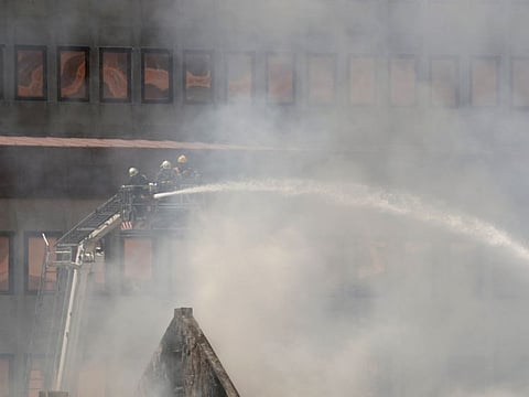 Firemen work at the parliament where a fire broke out in Cape Town, South Africa, January 2, 2022. 