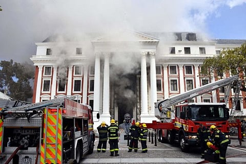 Firefighters work after a fire broke out in the Parliament in Cape Town, South Africa, January 2, 2022.