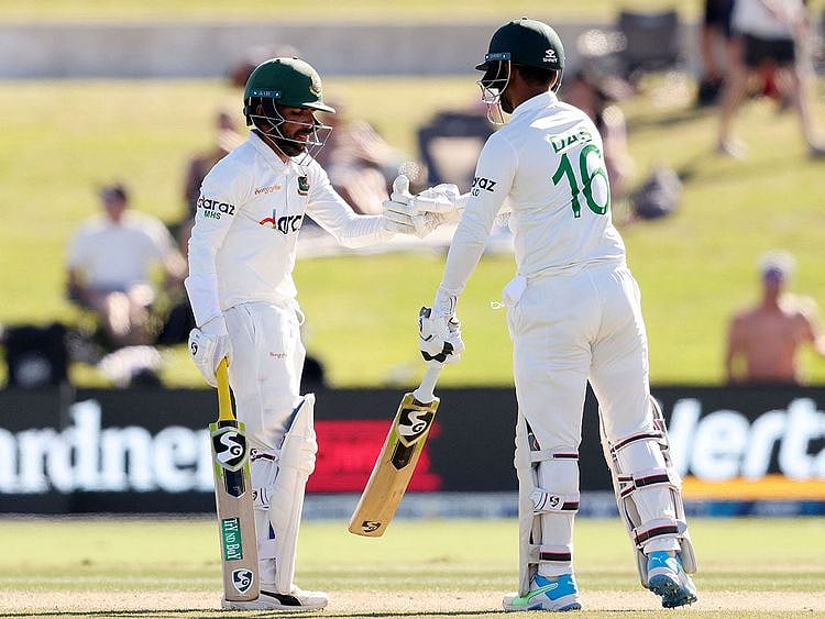 Bangladesh's batsmen Mominul Haque and Liton Das bump gloves at the Bay Oval in Mount Maunganui 
