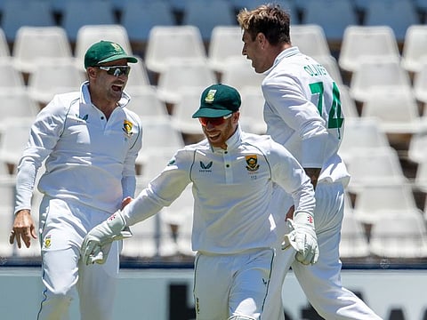 South Africa's Duanne Olivier, right, celebrates with teammates after dismissing India's batsman Ajinkya Rahane 