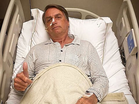 This picture obtained from the twitter official account of Brazil's President Jair Bolsonaro (@jairbolsonaro), shows Brazil's President Jair Bolsonaro posing for a picture while hospitalized due to an intestinal obstruction, in Sao Paulo, Brazil.