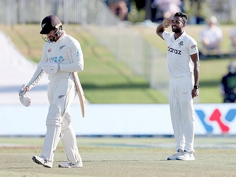 Bangladesh's Ebadot Hossain, right, celebrates the wicket of New Zealand's Tom Blundell, left, on day four of the first cricket test at Bay Oval in Mount Maunganui, New Zealand, on Tuesday. 
