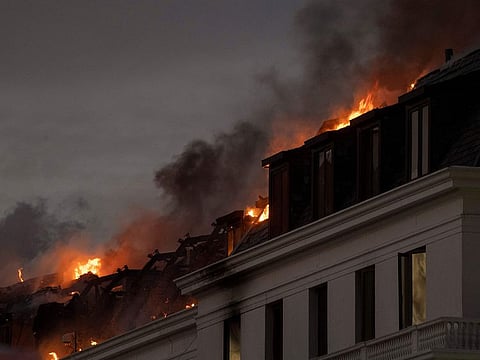 Flames arise from the National Assembly, the main chamber of the South African Parliament buildings, after a fire that broke out the day before restarted, on January 3, 2022, in Cape Town. 