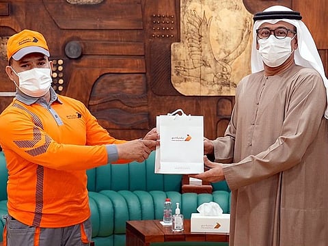 Dubai Municipality director-general Dawoud Al Hajiri (R) honoured employee Rahul Amin Siraj for his humanitarian act