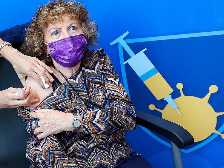  A woman receives a fourth dose of Pfizer vaccine in Tel Aviv on January 3, 2022.