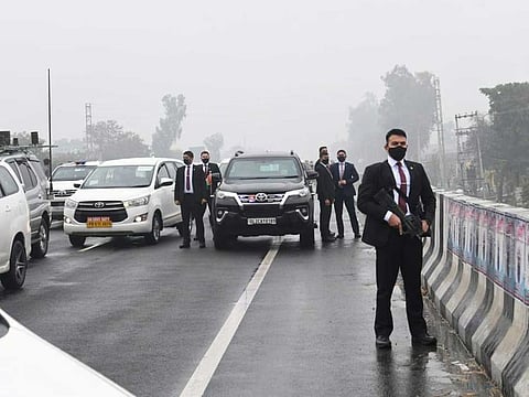 Securitymen guard the convoy of India's Prime Minister Narendra Modi on a bridge in Punjab on Wednesday.