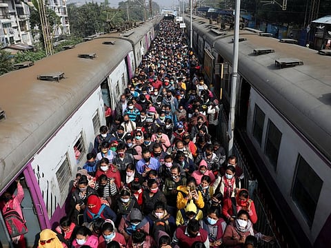Commuters leave a platform after disembarking from a suburban train at a railway station on the outskirts of Kolkata, India, January 5, 2022. 