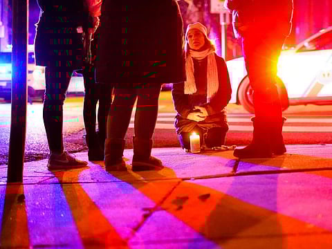 People gather to pay their respects after a deadly house fire, on January 5, 2022, in the Fairmount neighbourhood of Philadelphia. 