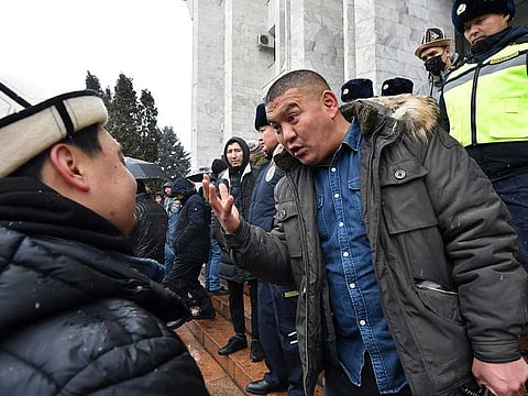 Protesters talk to each other as they gather in support of Kazakh opposition and against deploying Kyrgyzstan's troops to Kazakhstan during a rally in Bishkek, Kyrgyzstan, Friday, Jan. 7, 2022.