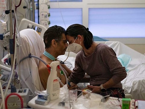 Amelie and Ludo Khayat at the COVID-19 intensive care unit of the La Timone hospital in Marseille, southern France, on December 23, 2021. Ludo, 41, is recovering after 24 days in a coma and on a ventilator. Amelie began visiting her husband after he tested negative for the virus. Twelve COVID patients in Marseille were found to have been infected with the  new IHU strain. 