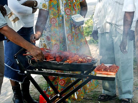 People prepare barbeque in a Garden on the Corniche in 
Abu Dhabi