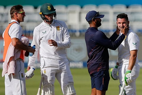 South African captain Dean Elgar (right) receives medical attention after being hit by a ball during the third day of the second Test against India at The Wanderers on Thursday.
