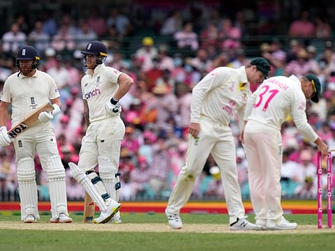 England's Ben Stokes (second from left) and Jonny Bairstow (left) wait for a umpire's review while Australia's David Warner and Steve Smith check the bails on the stumps during the third day of the fourth Ashes Test at Sydney Cricket Ground.
