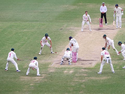 England's James Anderson plays a shot on the final delivery surrounded by Australian players at the end of day five of the fourth Ashes Test at Sydney Cricket Ground on Sunday.