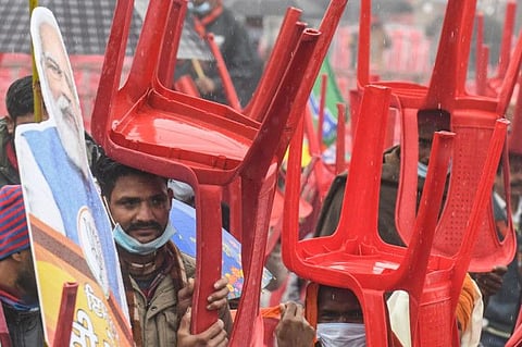 Bharatiya Janata Party (BJP) supporters hold chairs and cut-outs with portrait of BJP leader and India's Prime Minister Narendra Modi as they await his arrival during a rally ahead of the state assembly elections in Ferozepur on January 5, 2022 which was reportedly cancelled later citing security concerns.
