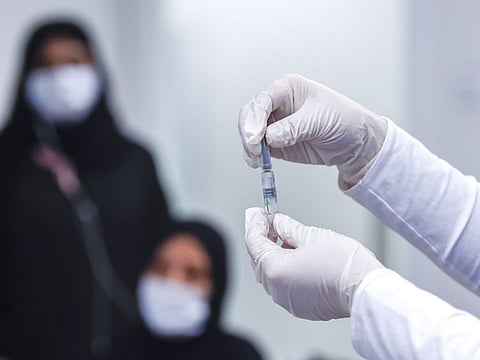 A healthcare professional readies a COVID-19 vaccine at a medical facility in Jumeirah, Dubai