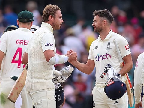 England's Stuart Broad (left) and James Anderson celebrate after the fourth Test against Australia ended in a draw in Sydney on Sunday.