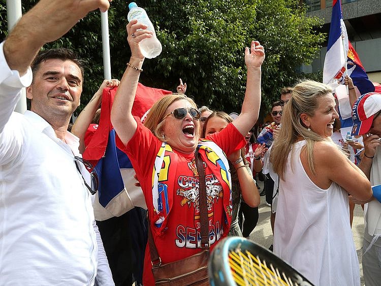 Fans of Serbia's Novak Djokovic react to news of his overturned ruling 