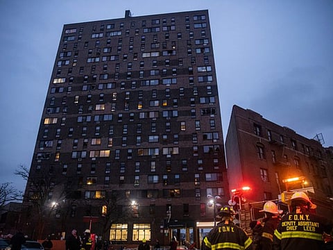 Emergency personnel work at the scene of a fatal fire at an apartment building in the Bronx on Sunday, Jan. 9, 2022, in New York.