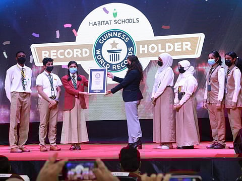 Student representatives of Habitat Schools receive the honour from the Guinness Book of World Records in Ajman on Monday.