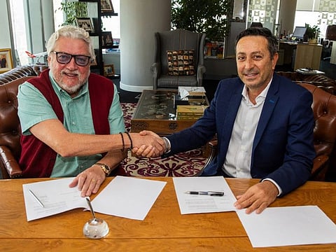 Raed Barqawi (right) signing the publishing agreement for ‘Dare to Dream: How Mohammed bin Rashid Made His Dream of Dubai Come True’ with Ian Fairservice, managing partner of Motivate Media Group. 