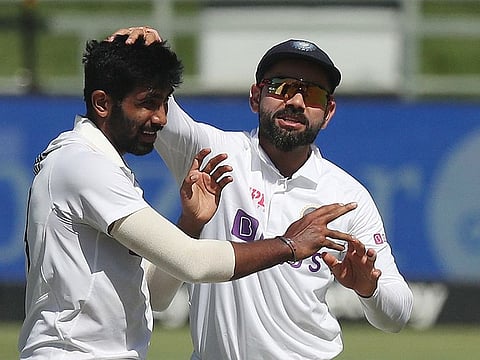 Indian pacer Jasprit Bumrah celebrates the wicket of Keegan Petersen with skipper Virat Kohli during the second day of the third Test at Newlands on Wednesday.