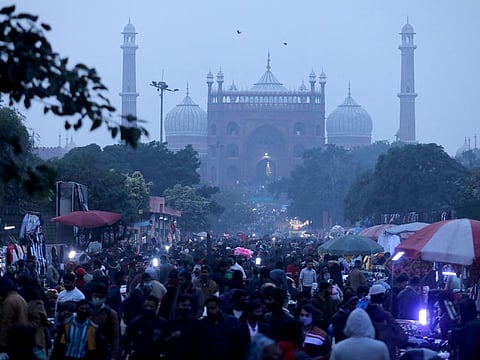 People shop at a crowded market in the old quarters of Delhi, on January 11, 2022. 