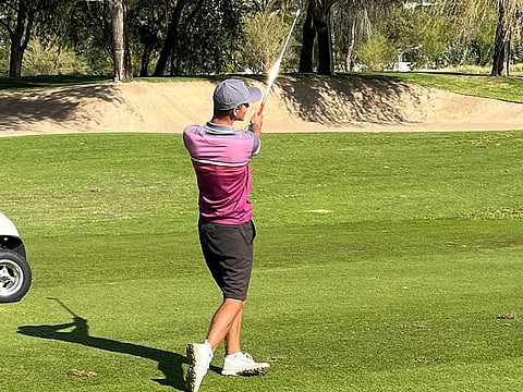 First round leader James Nash plays his approach shot  on the par-four 14th hole on the Faldo Course at Emirates Golf Club in 2022 Emirates Amateur Open on Friday.