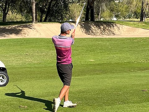 First round leader James Nash plays his approach shot  on the par-four 14th hole on the Faldo Course at Emirates Golf Club in 2022 Emirates Amateur Open on Friday.