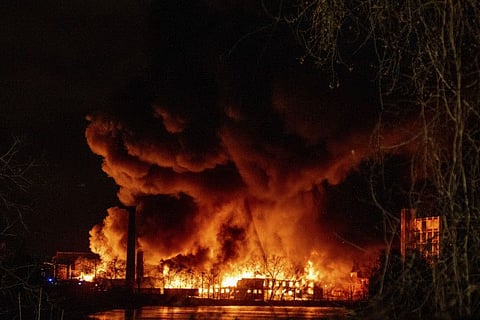 A six alarm chemical fire blazes across the Passaic River in Passaic, New Jersey, on January 14, 2022. 