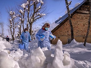 Look: Vaccine workers trek in Kashmir’s snowy mountains