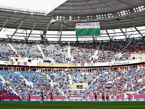 Fans watch a match at the 974 stadium in Doha on December 18, 2021. Qatar World Cup ticket sales were launched at reduced prices on Wednesday.