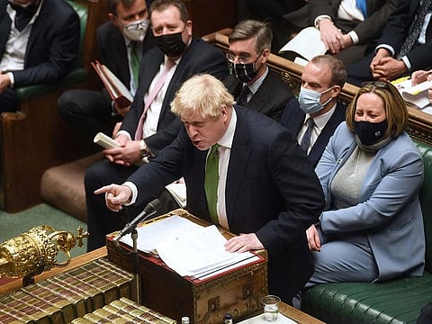 A handout photograph released by the UK Parliament shows Britain's Prime Minister Boris Johnson attending Prime Minister's Questions (PMQs) in the House of Commons in London on January 19, 2022. 