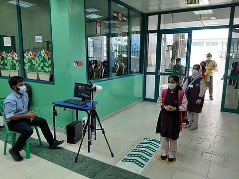 Children queuing up for temperature checks during entry to The Model School Abu Dhabi. File photo for illustrative purpose only