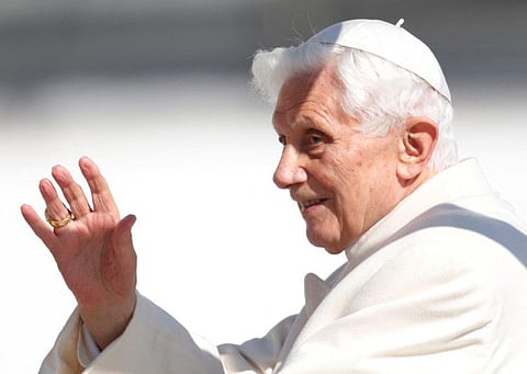 Pope Benedict XVI waves to the faithful as he arrives in St Peter's Square to hold his last general audience at the Vatican February 27, 2013. 