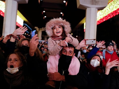 Children react as they see Gaspar, one of the Three Wise Men, during the annual Epiphany parade amid the COVID-19 surge in Madrid, Spain, January 5, 2022. 